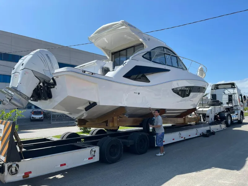 Slide: The Image of 2021 Evolve 400HT yacht on trailer, ready for transport under clear blue sky. - 3