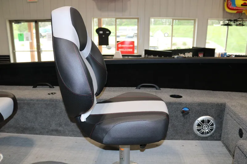 Slide: The Image of 2023 Alumacraft Competitor 185 CS boat seat, black and white design, indoor showroom. - 13
