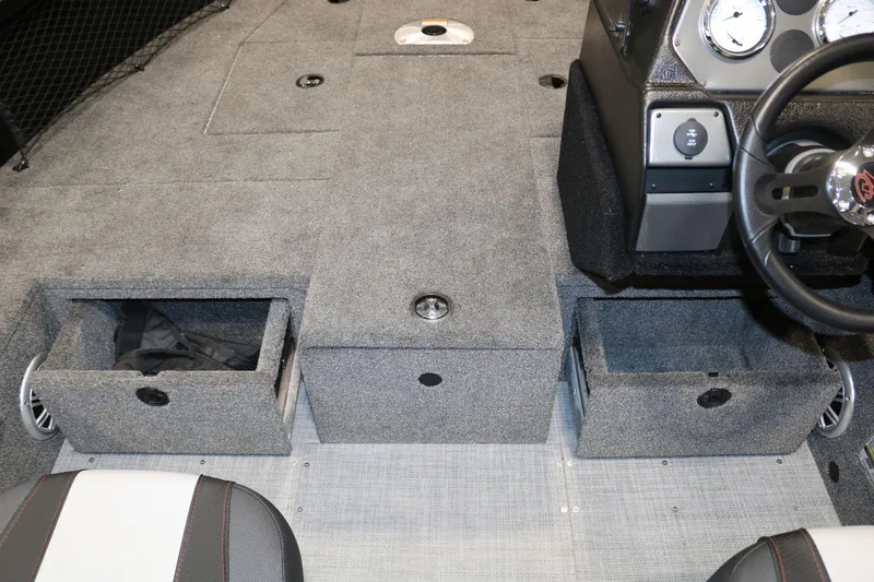 Slide: The Image of 2023 Alumacraft Competitor 185 CS boat interior with storage compartments and steering console. - 15