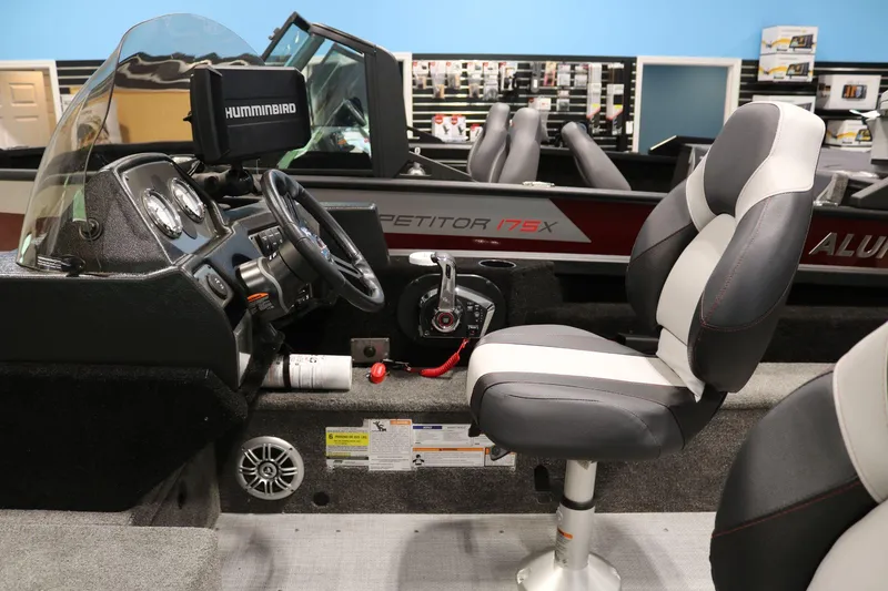 Slide: The Image of 2023 Alumacraft Competitor 185 CS boat interior with steering console and seating. - 16