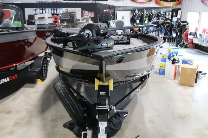 Slide: The Image of 2023 Alumacraft Competitor 185 CS boat displayed in showroom with accessories. - 2