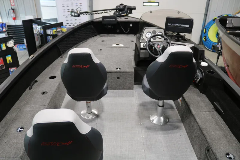 Slide: The Image of 2023 Alumacraft Competitor 185 CS boat interior with dual seats and steering console. - 21