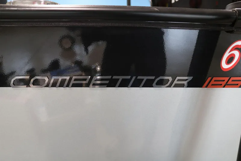 Slide: The Image of 2023 Alumacraft Competitor 185 CS boat logo on sleek black and white surface. - 22