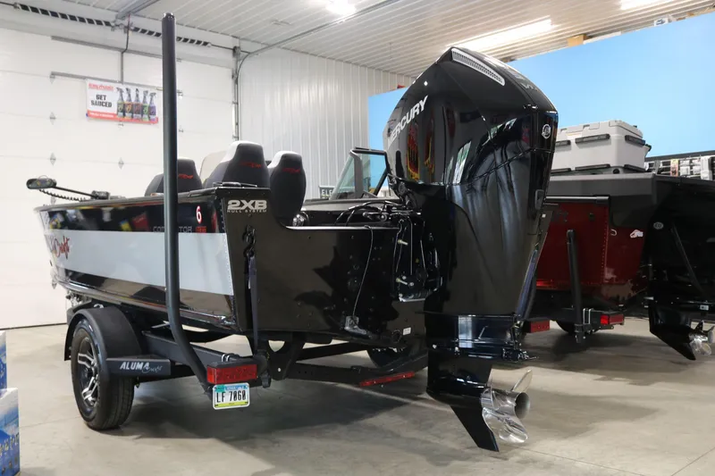 Slide: The Image of 2023 Alumacraft Competitor 185 CS boat with Mercury outboard motor in a showroom. - 6