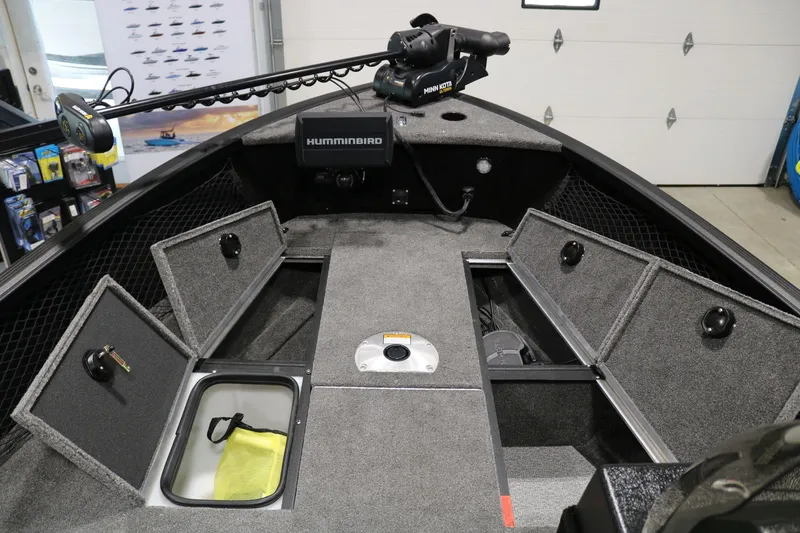 Slide: The Image of 2023 Alumacraft Competitor 185 CS boat interior with storage compartments and Humminbird electronics. - 9