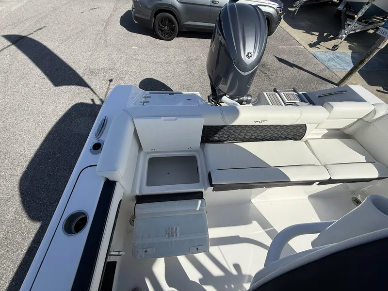 Slide: The Image of 2025 Tidewater 220 LXF boat interior with seating and outboard motor. - 13