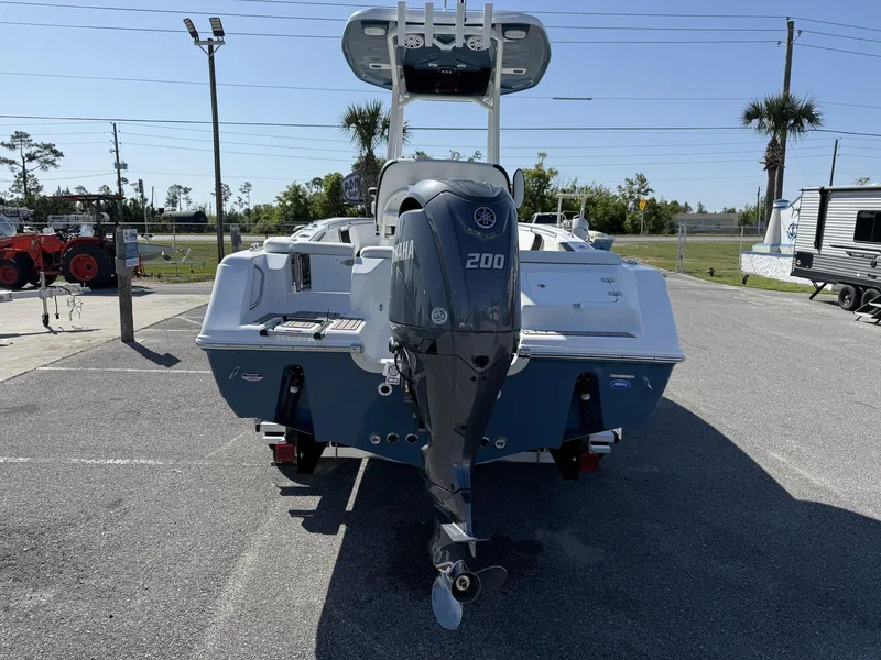 Slide: The Image of 2025 Tidewater 220 LXF boat with Yamaha 200 engine, parked outdoors. - 4