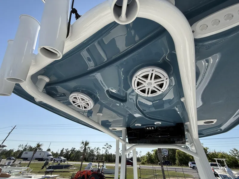 Slide: The Image of 2025 Tidewater 220 LXF boat T-top with speakers and rod holders, viewed from below. - 7