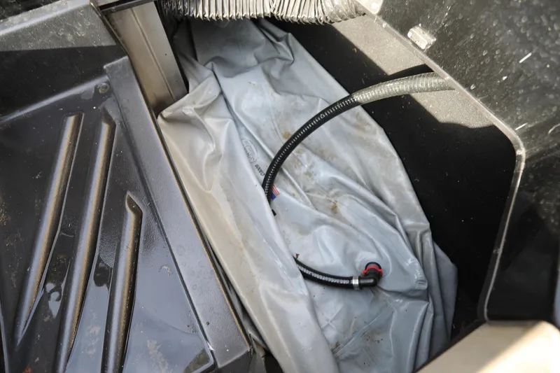 Slide: The Image of 2021 Centurion Ri245 boat interior with storage compartment and hose. - 17