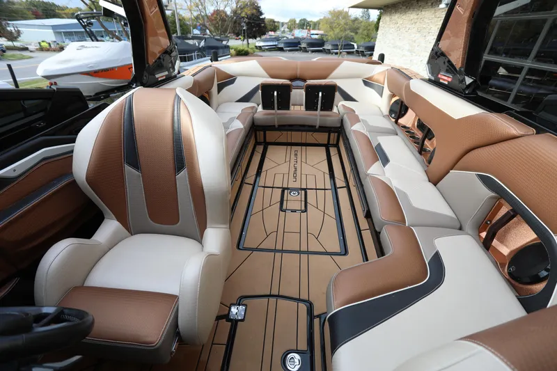 Slide: The Image of 2021 Centurion Ri245 boat interior with luxurious brown and cream seating. - 5