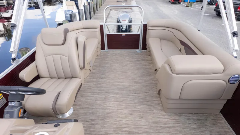 Slide: The Image of 2024 Bennington 20SSR pontoon boat interior with beige seating and steering console. - 10