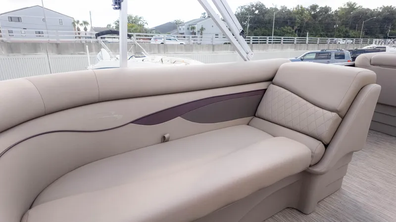 Slide: The Image of 2024 Bennington 20SSR boat interior with beige cushioned seating and elegant design. - 13