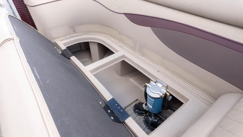 Slide: The Image of 2024 Bennington 20SSR boat storage compartment with open lid and visible equipment. - 14
