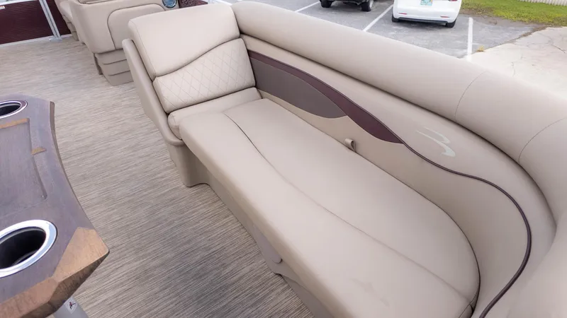 Slide: The Image of 2024 Bennington 20SSR boat interior with beige seating and cup holders. - 16