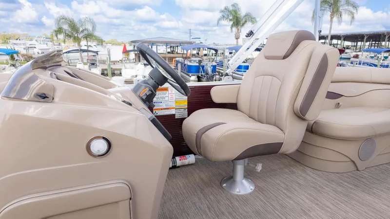 Slide: The Image of 2024 Bennington 20SSR boat interior with beige captain's chair and steering console. - 20