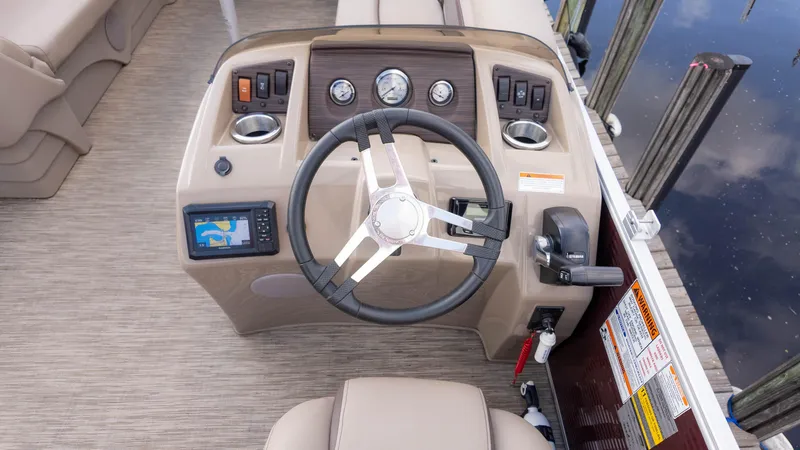 Slide: The Image of 2024 Bennington 20SSR boat dashboard with steering wheel and navigation system. - 21