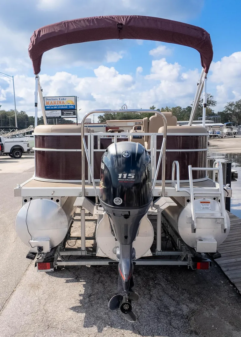 Slide: The Image of 2024 Bennington 20SSR pontoon boat with Yamaha 115 outboard motor at marina. - 5
