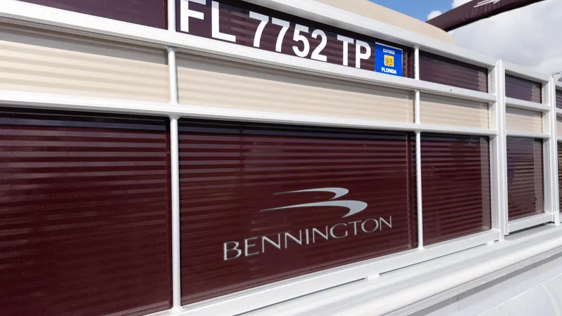 Slide: The Image of 2024 Bennington 20SSR pontoon boat with Florida registration, maroon and beige exterior. - 6