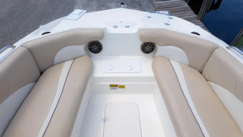 Slide: The Image of 2017 NauticStar 203 SC boat interior with beige seating and speakers. - 11