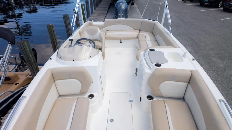 Slide: The Image of 2017 NauticStar 203 SC boat with beige seating, docked by the water. - 12