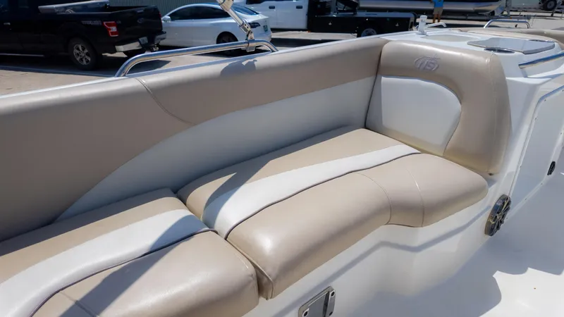 Slide: The Image of 2017 NauticStar 203 SC boat interior with beige and white cushioned seating. - 16