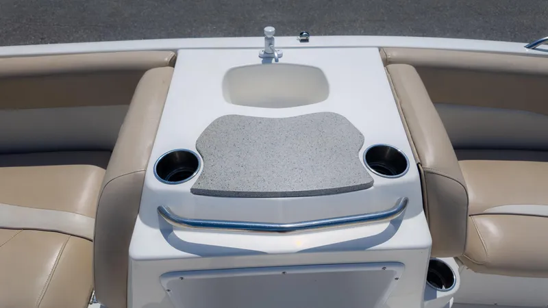 Slide: The Image of 2017 NauticStar 203 SC boat interior with sink, countertop, and cup holders. - 18