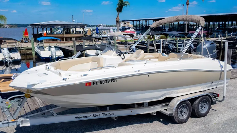 Slide: The Image of 2017 NauticStar 203 SC boat on trailer at marina, sunny day. - 2