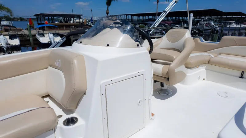Slide: The Image of 2017 NauticStar 203 SC boat interior with beige seating and steering console. - 25