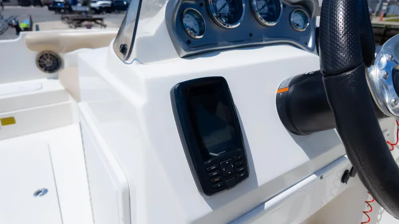 Slide: The Image of 2017 NauticStar 203 SC boat dashboard with steering wheel and navigation system. - 28