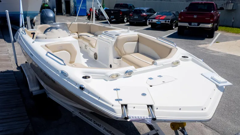 Slide: The Image of 2017 NauticStar 203 SC boat on trailer in parking lot, featuring beige seating and white exterior. - 3