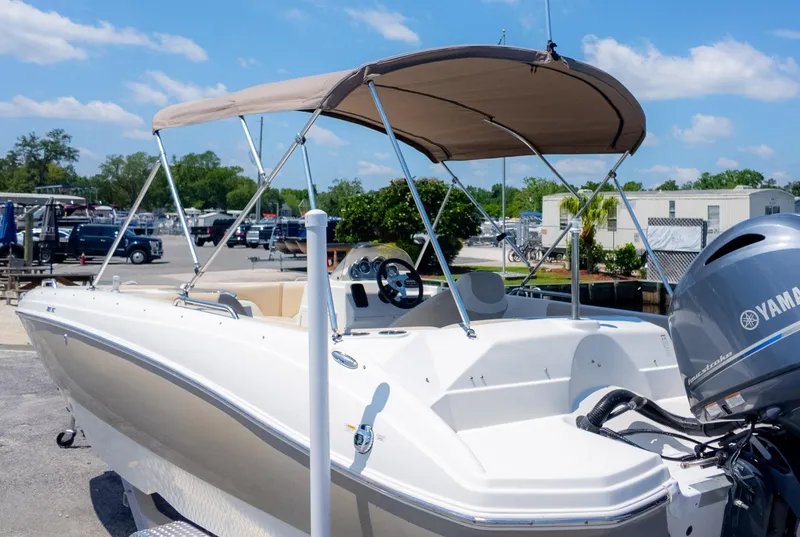 Slide: The Image of 2017 NauticStar 203 SC boat with Yamaha engine, docked under clear blue sky. - 32