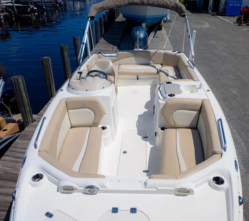 Slide: The Image of 2017 NauticStar 203 SC boat with beige seating, docked by the water. - 7