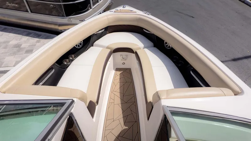 Slide: The Image of 2015 Regal 2500 boat interior with beige and white seating, geometric flooring design. - 10