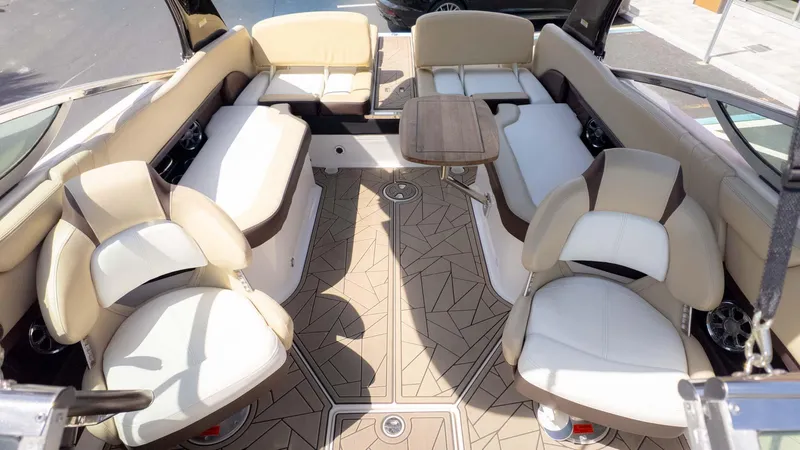 Slide: The Image of Luxurious interior of a 2015 Regal 2500 boat with plush seating and a wooden table. - 11