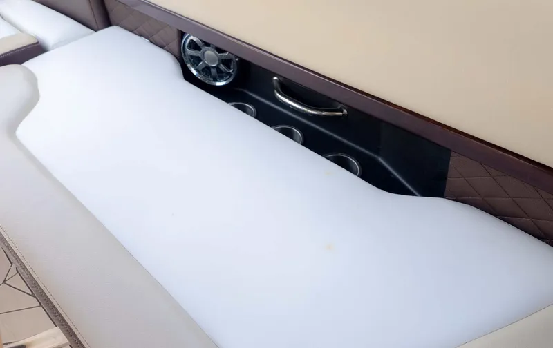 Slide: The Image of 2015 Regal 2500 boat interior with cushioned seating and cup holders. - 15