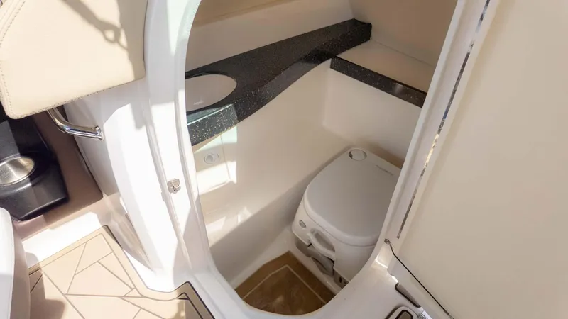 Slide: The Image of 2015 Regal 2500 boat interior with compact bathroom and toilet. - 18