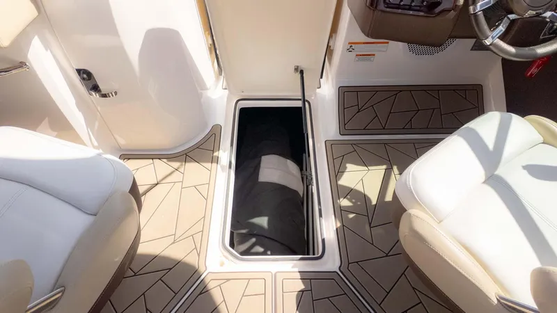 Slide: The Image of 2015 Regal 2500 boat interior with open storage compartment and stylish seating. - 19