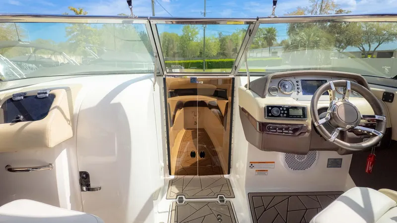 Slide: The Image of Interior view of 2015 Regal 2500 boat cockpit with steering wheel and dashboard controls. - 20