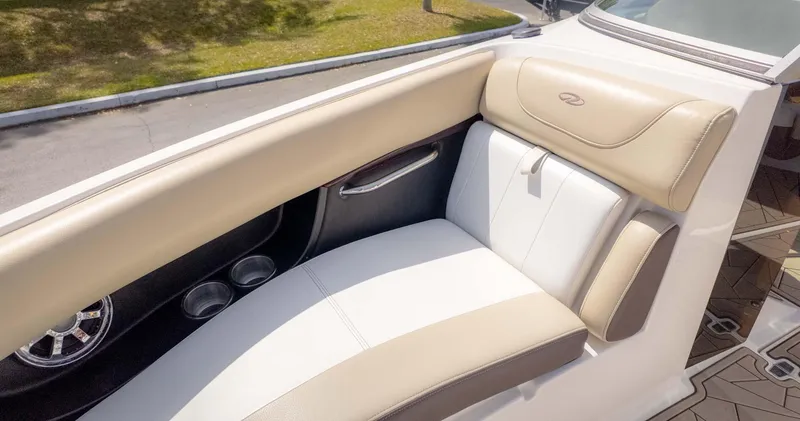 Slide: The Image of 2015 Regal 2500 boat interior with beige and white seating, cup holders, and sleek design. - 24