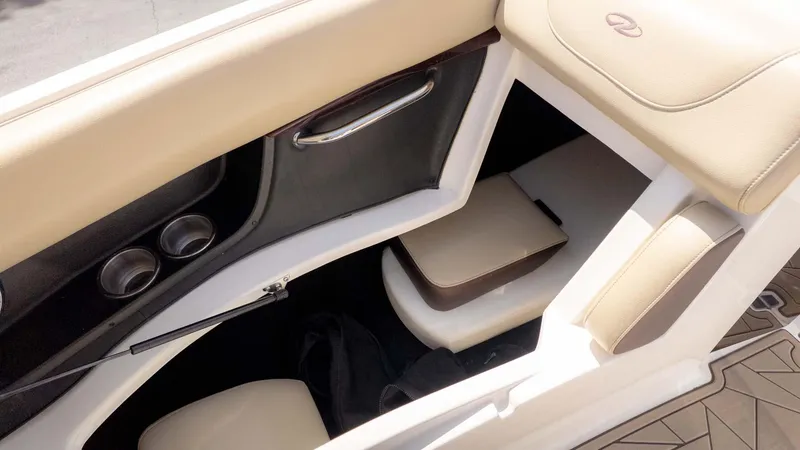 Slide: The Image of Interior of a 2015 Regal 2500 boat with beige seating and storage compartment. - 25