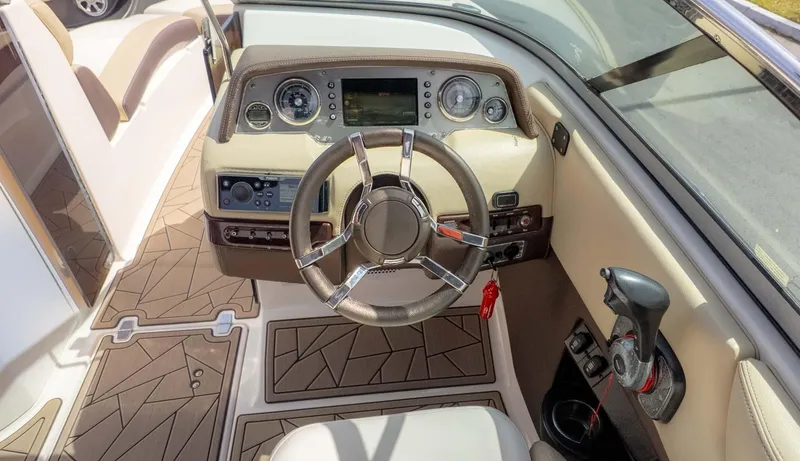 Slide: The Image of 2015 Regal 2500 boat cockpit with steering wheel and control panel. - 27