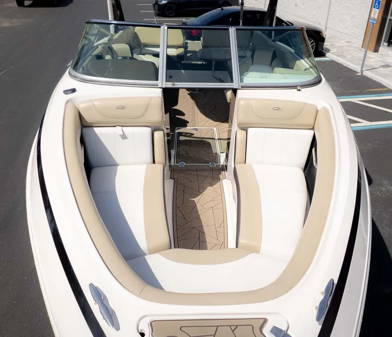 Slide: The Image of 2015 Regal 2500 boat with beige and white seating, parked in a lot. - 3