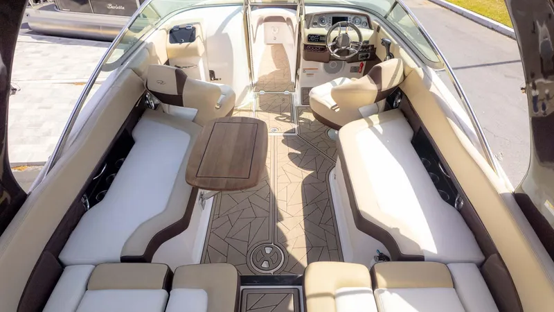 Slide: The Image of 2015 Regal 2500 boat interior with beige seating and wooden table. - 9