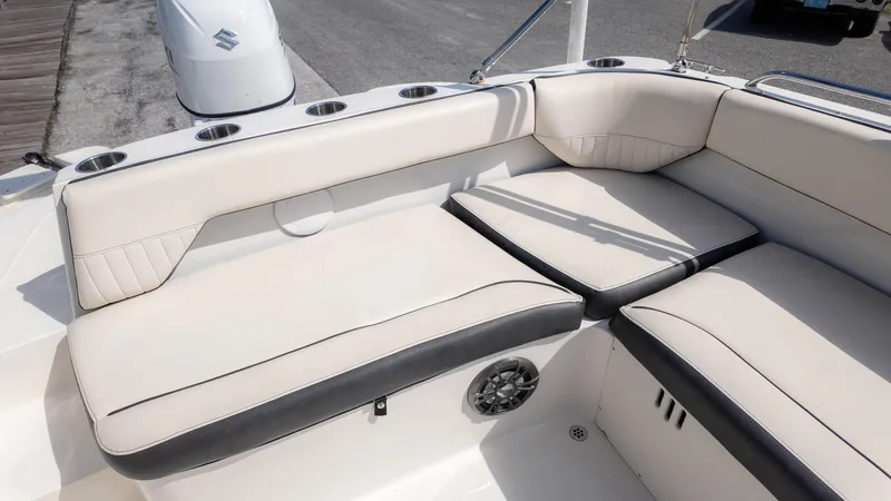 Slide: The Image of 2021 Stingray 192SC boat interior with white cushioned seating and cup holders. - 10