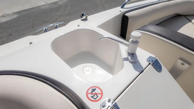 Slide: The Image of 2021 Stingray 192SC boat sink with faucet and no-smoking sign. - 14