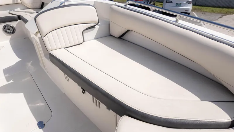 Slide: The Image of 2021 Stingray 192SC boat interior with white cushioned seating and sleek design. - 16