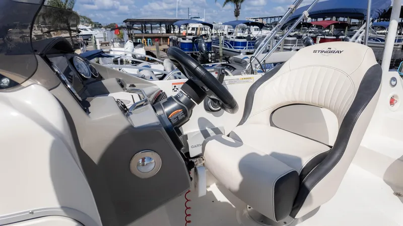 Slide: The Image of 2021 Stingray 192SC boat interior with steering wheel and captain's seat. - 20