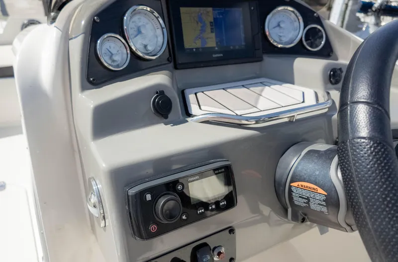 Slide: The Image of 2021 Stingray 192SC boat dashboard with gauges, GPS, and controls. - 21