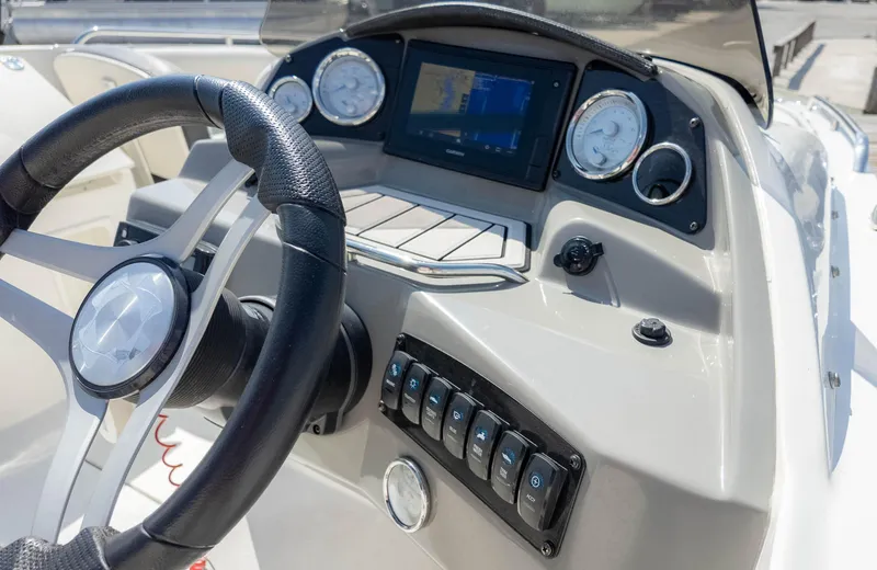 Slide: The Image of 2021 Stingray 192SC boat dashboard with steering wheel and control panel. - 22