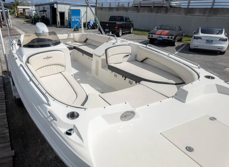 Slide: The Image of 2021 Stingray 192SC boat with spacious seating, parked near classic and modern cars. - 3